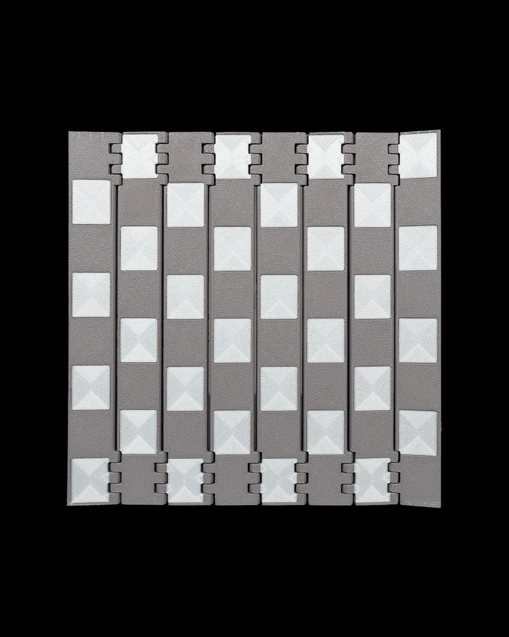 Close-up of black and white castle-inspired 3D printed chess pieces
