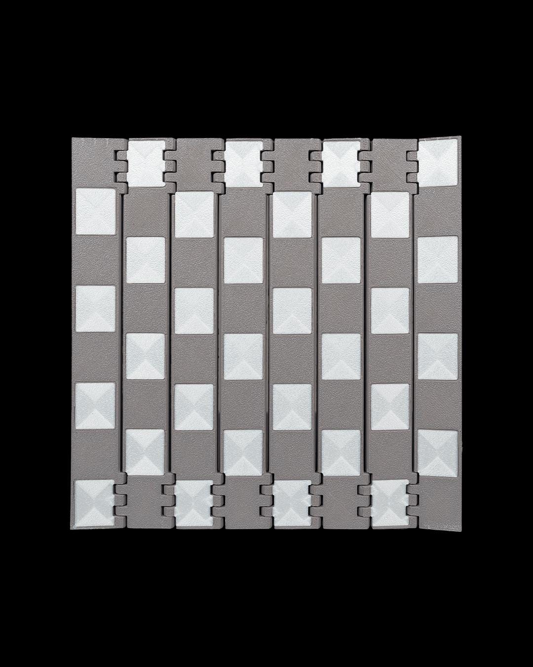 Close-up of black and white castle-inspired 3D printed chess pieces