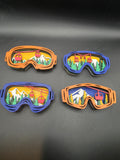 Four 3D wood ski lift ornaments in blue and orange frames with layered mountain scenes