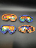 Four 3D wood ski lift wall art pieces in blue and orange frames with layered mountain scenes