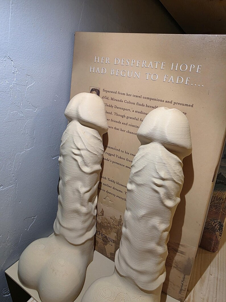 Close-up of cream Balls Deep penis bookends showing printed detail