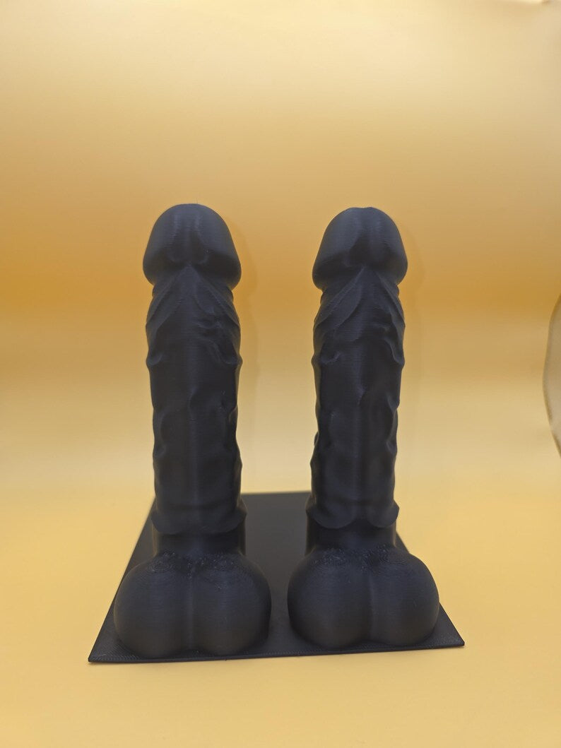 Black Balls Deep penis bookend pair on a base plate, front view