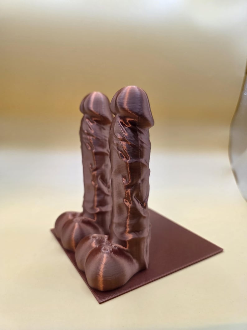 Copper Balls Deep penis bookends, angled view showing the base plate