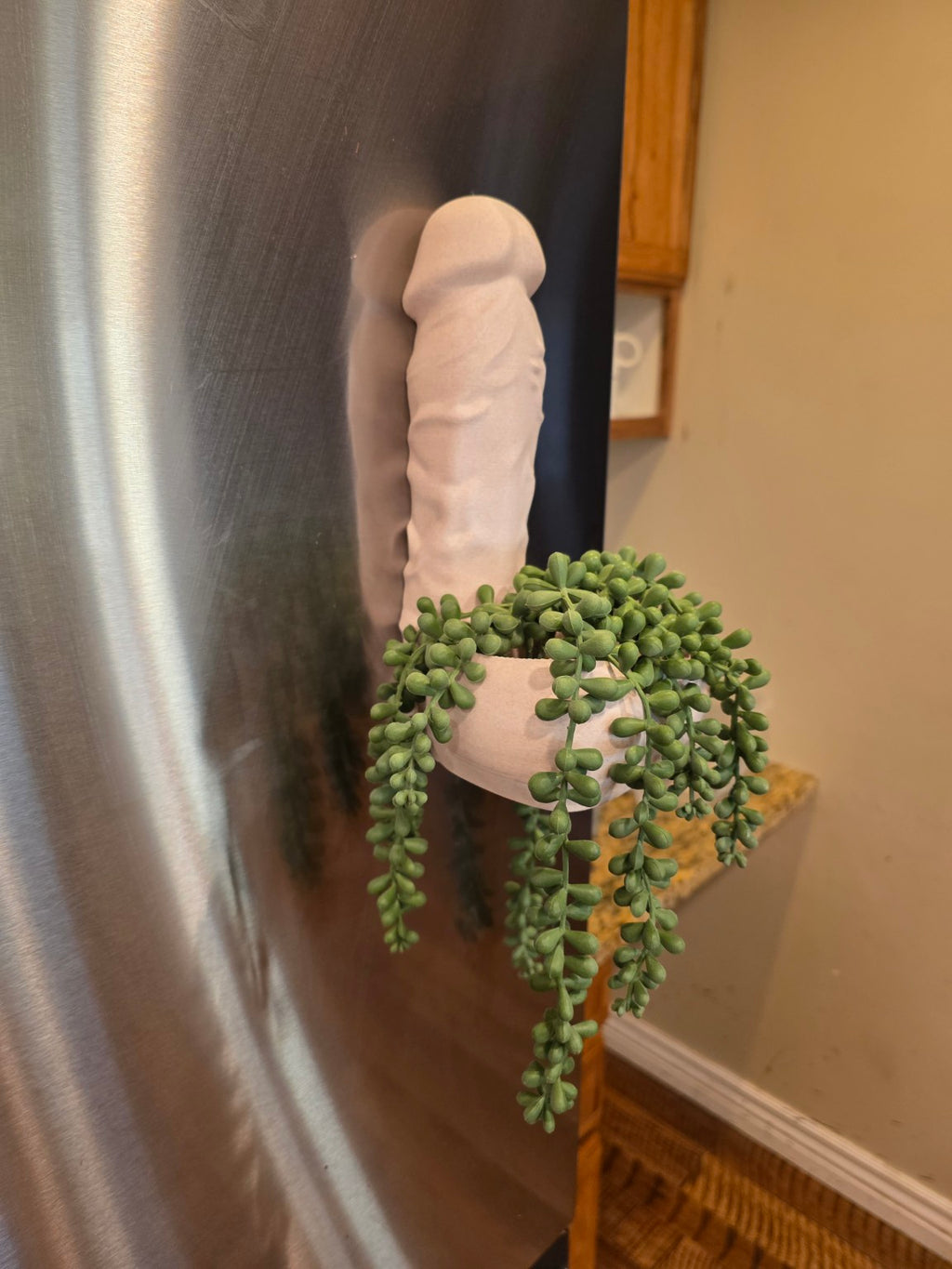 Side view of Big Girtha magnetic planter with trailing greenery