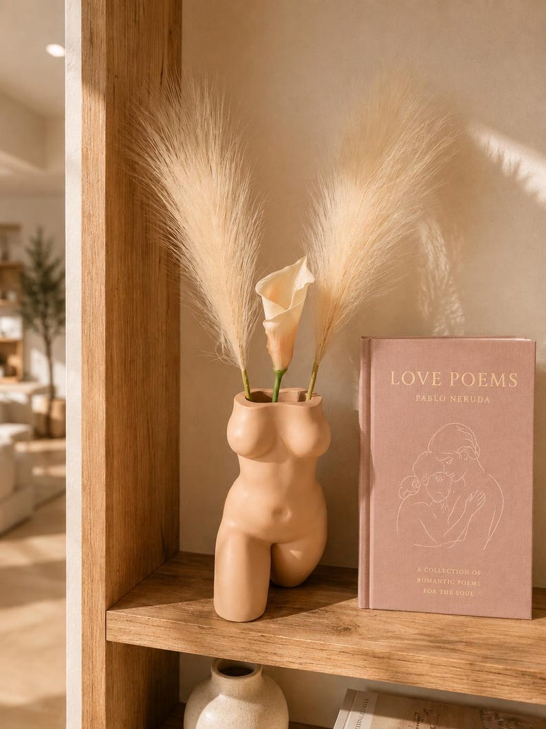 Peach Confident Curves body planter with pampas and calla lilies on a shelf