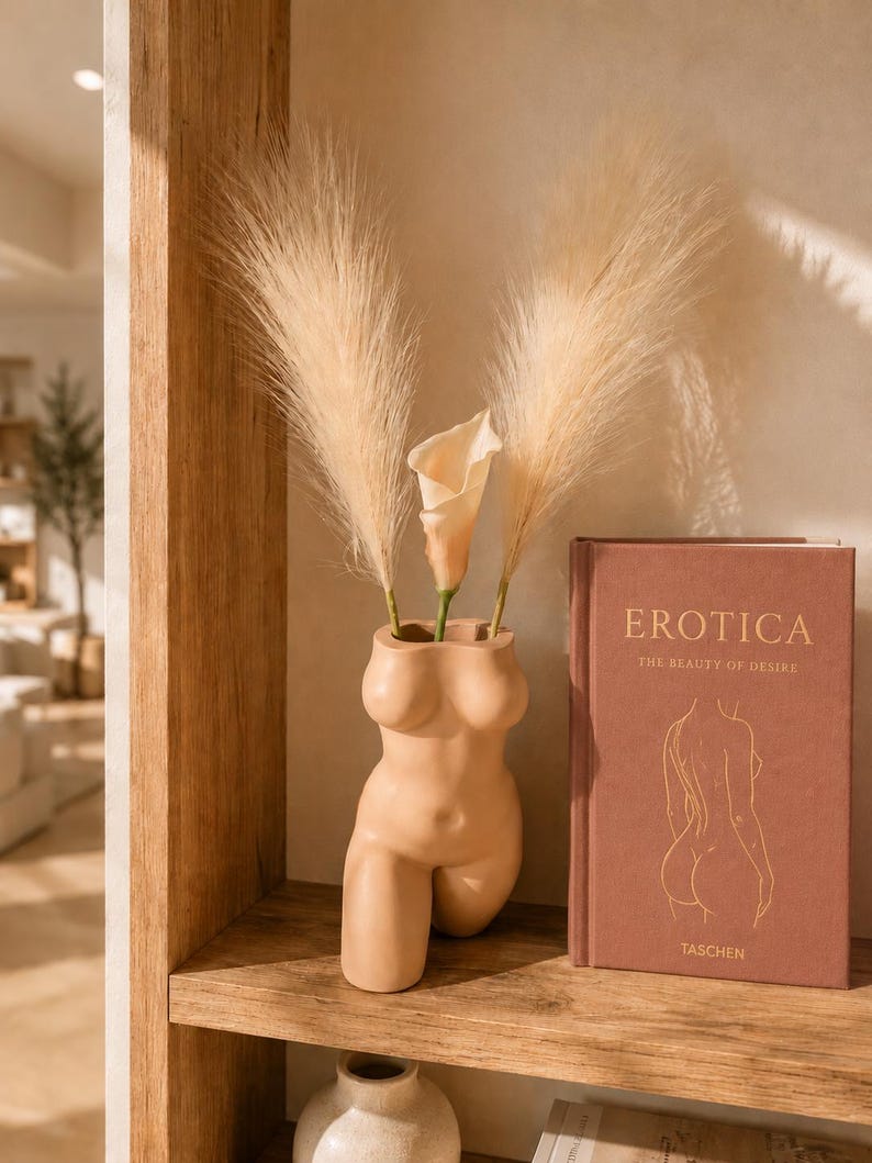 Confident Curves planter with dried florals beside a book