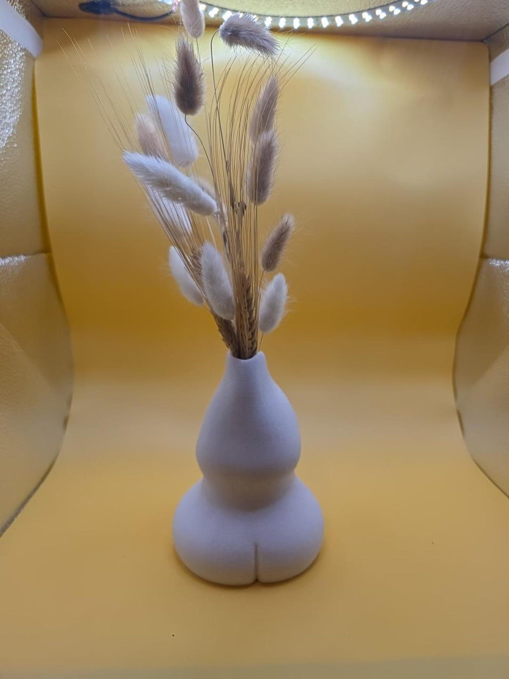 Light gray Embrace vase with dried bunny tails, front view