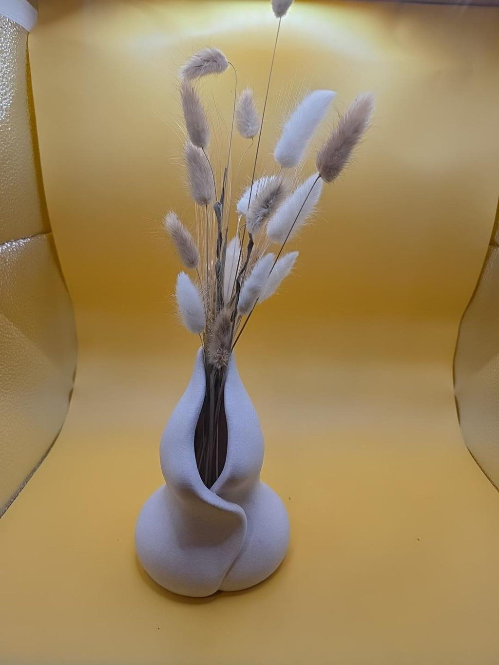 Light gray Embrace vase showing the flowing front opening