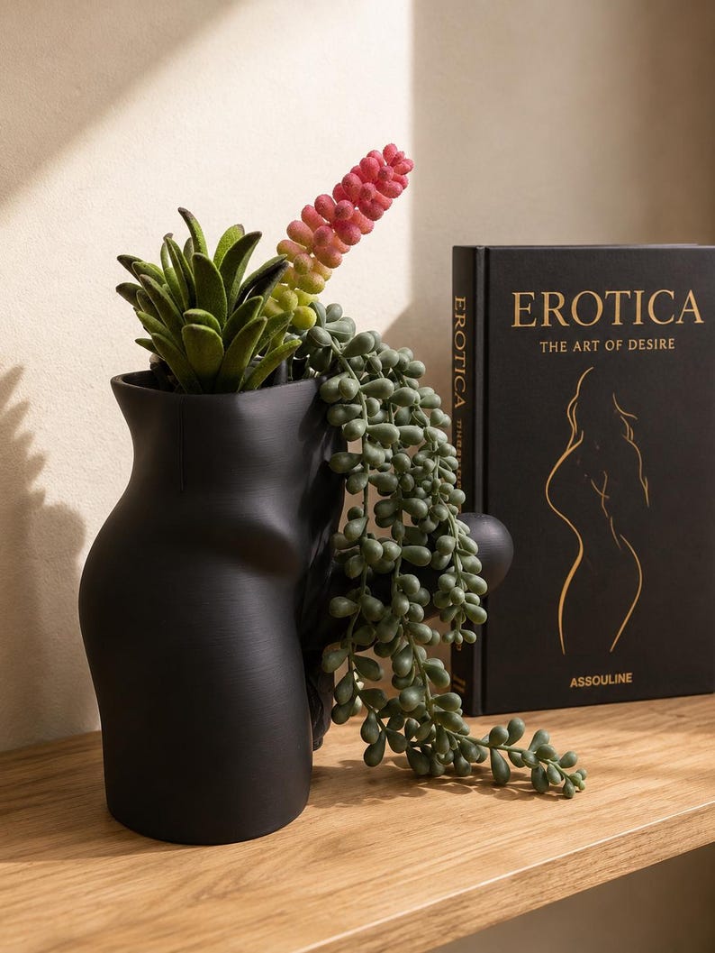 Black Good Morning Wood planter with succulents and trailing string of pearls beside a book