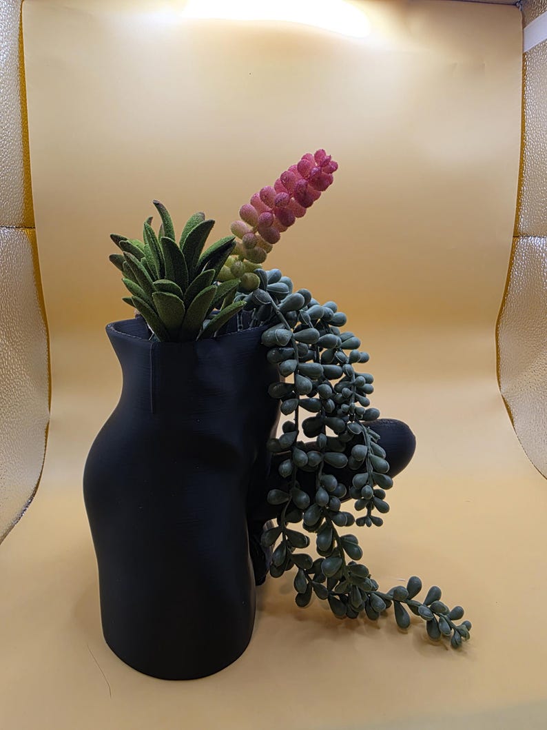 Black Good Morning Wood planter with trailing plant, angled view