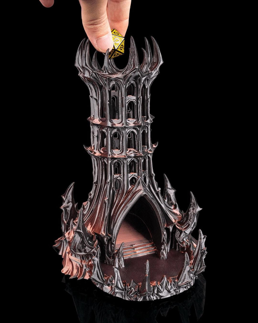 Hand dropping a die into the top of the Obsidian Citadel dice tower