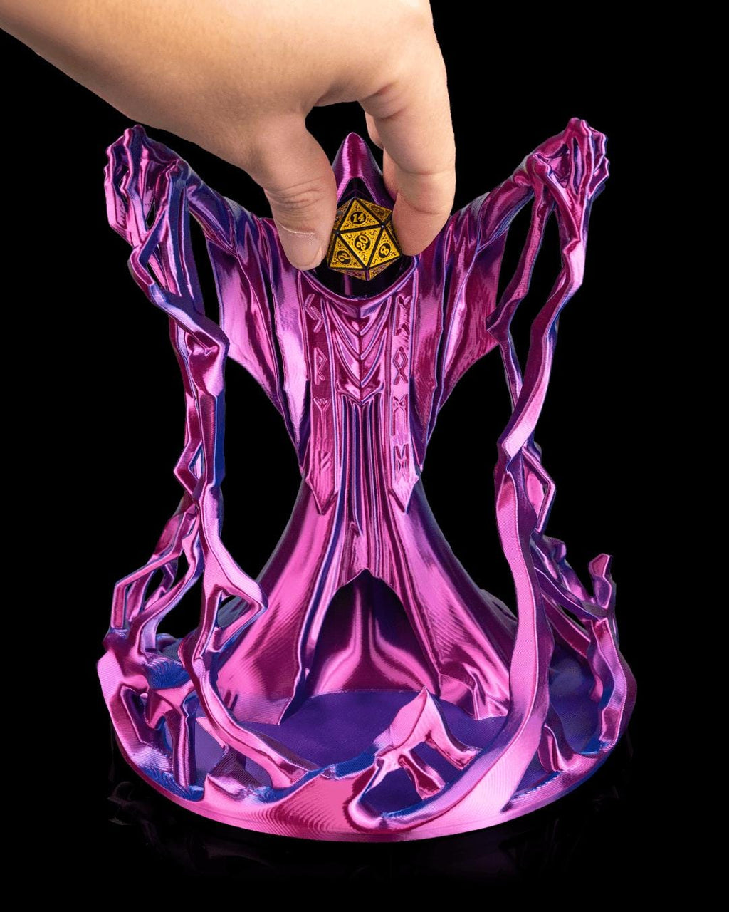 Hand dropping a gold die into the hood of the Behold the Wizard dice tower