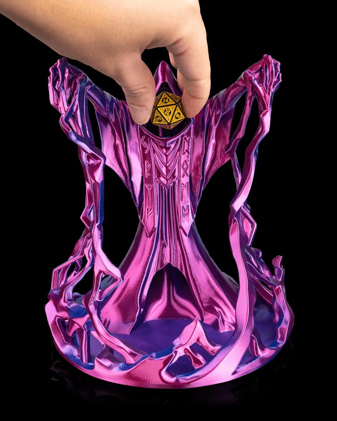 Hand dropping a gold die into the hood of the Behold the Wizard dice tower