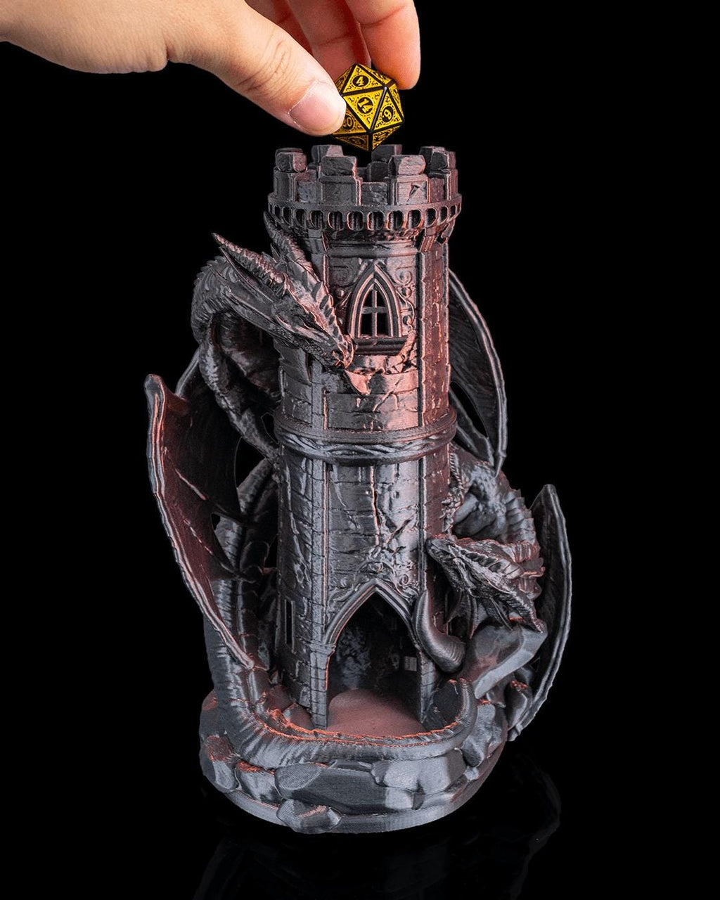 Hand dropping a gold die into the top of the Twin Fate dice tower
