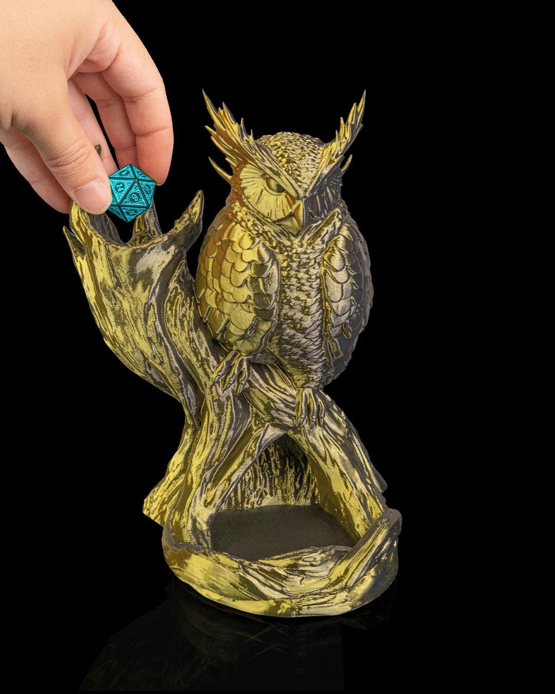 Hand dropping a teal die into The Omen Owl dice tower