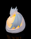 Dragon sphere lamp lit, front view with the dragon's wing across the orb
