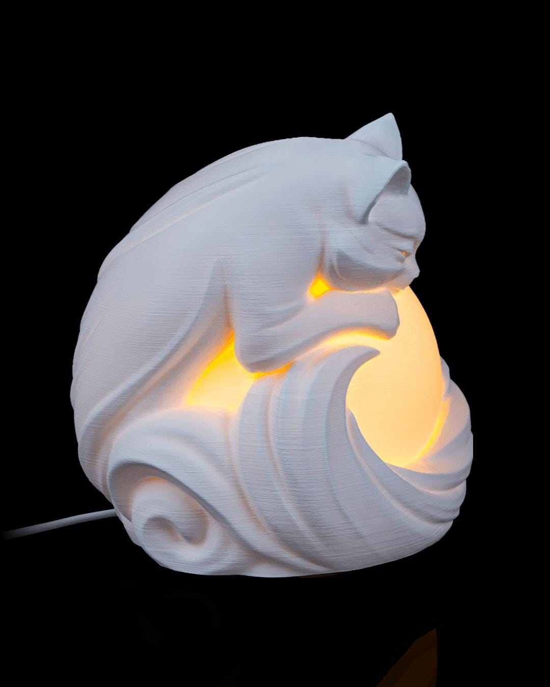 Feline sphere lamp lit, side view with power cord