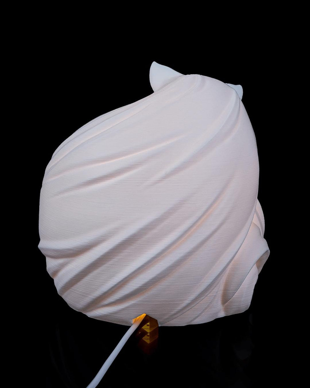 Feline sphere lamp, back view showing the swept tail