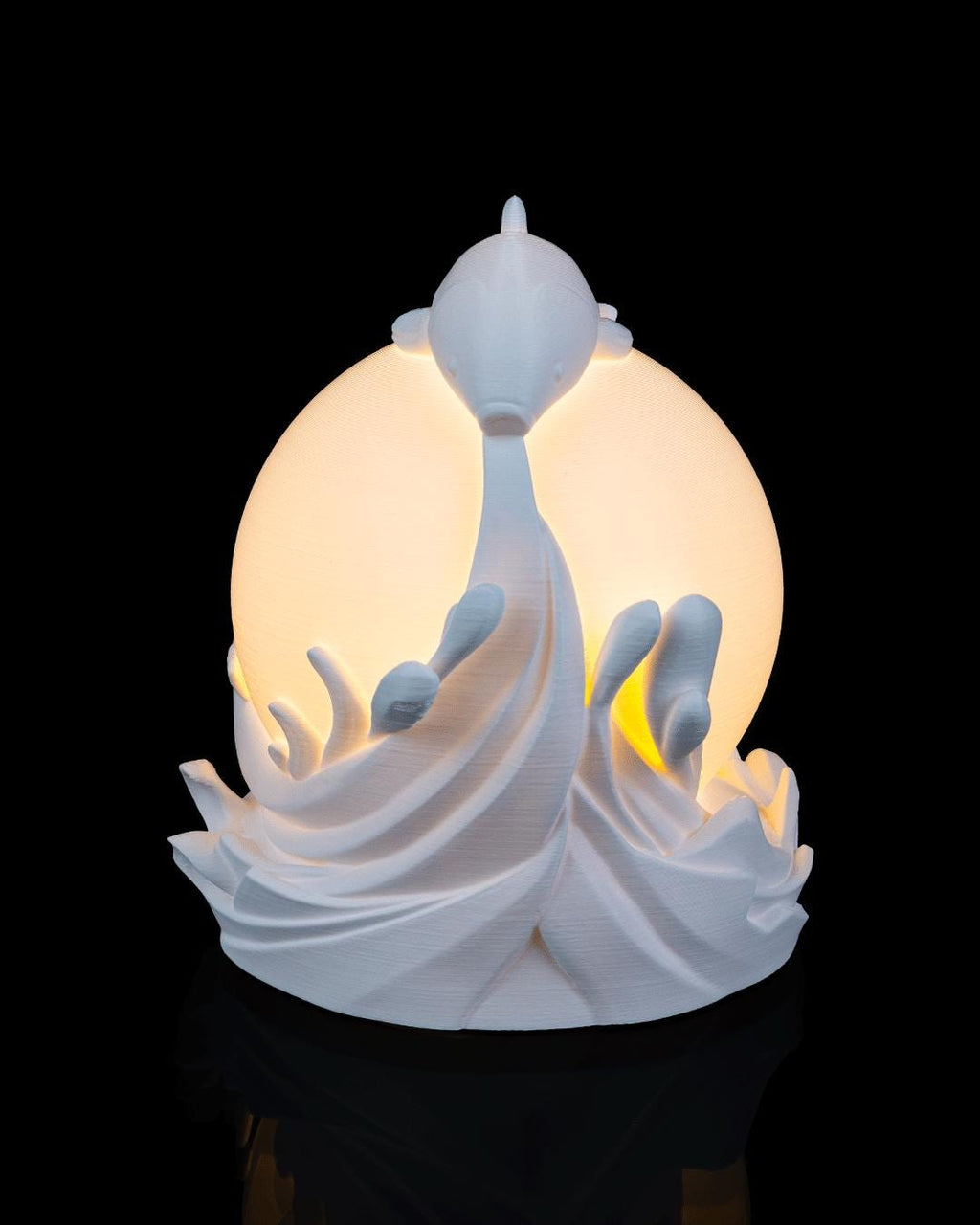 Twin fish sphere lamp lit, front view with two fish rising beside the orb
