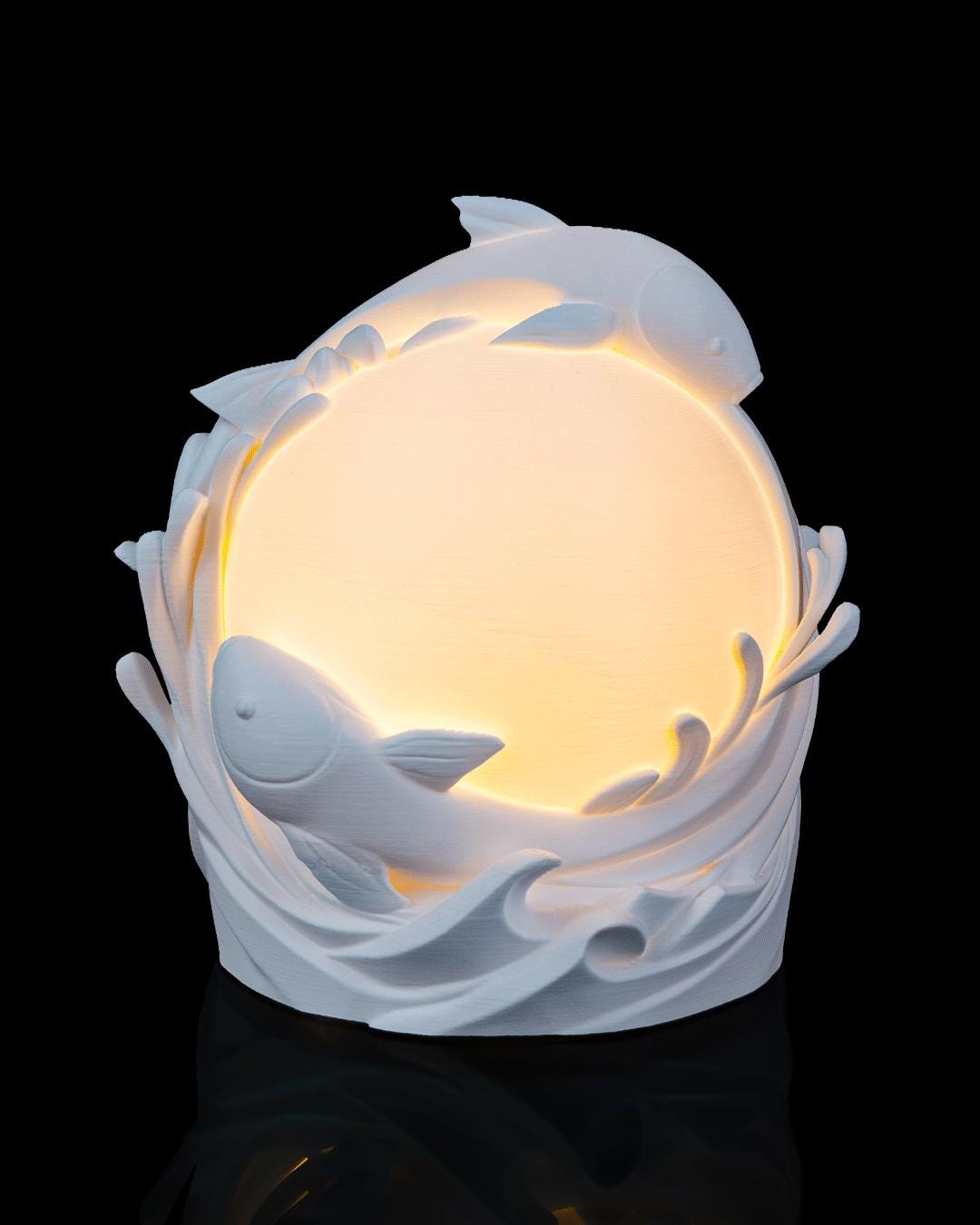 Twin fish sphere lamp lit, angled view