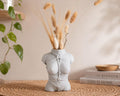 White Knotty Girl rope body vase with dried pampas on a side table