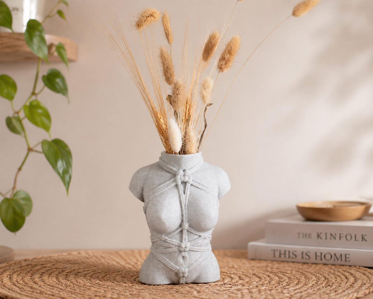 White Knotty Girl rope body vase with dried pampas on a side table