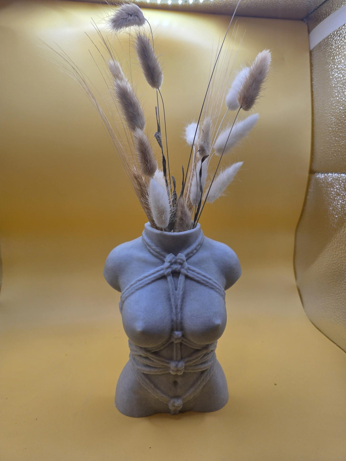 Gray Knotty Girl body vase with dried stems, front view