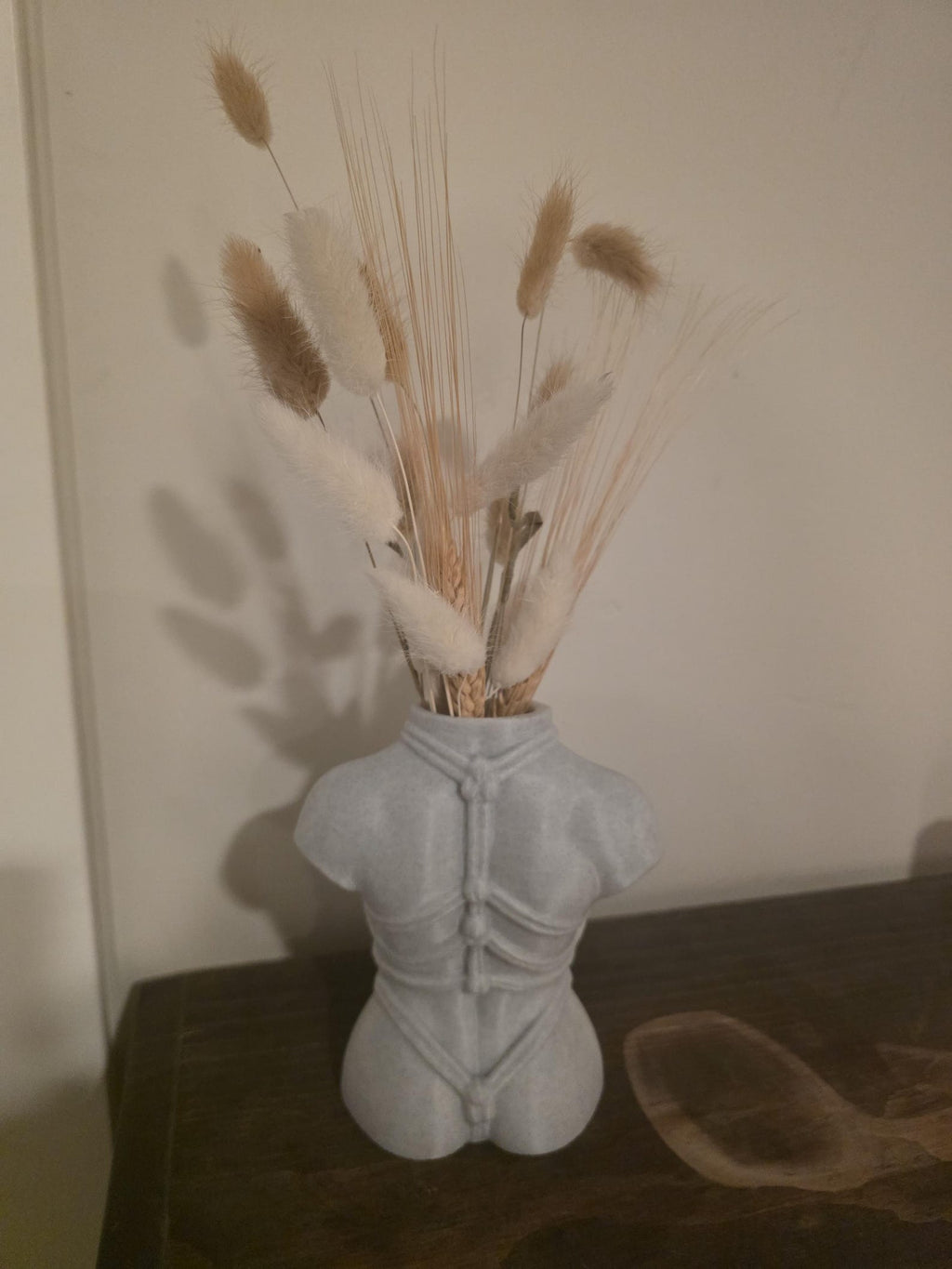Light gray Knotty Girl vase with dried florals, rear view