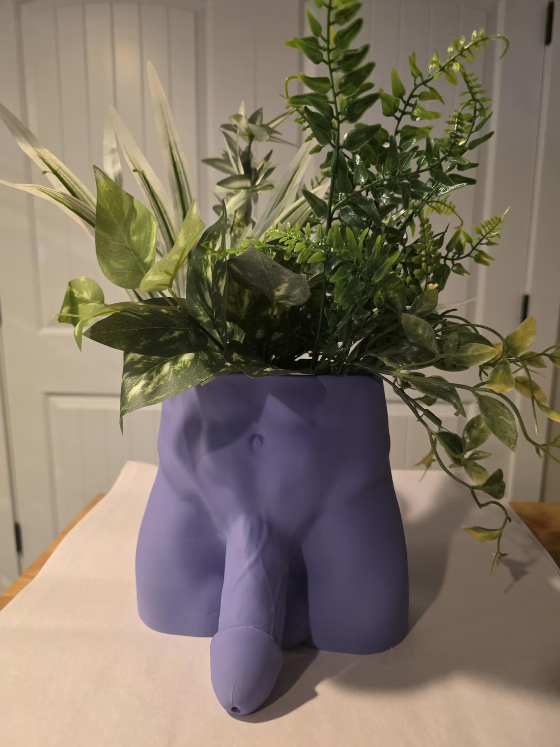 Purple Monster Dong planter filled with greenery
