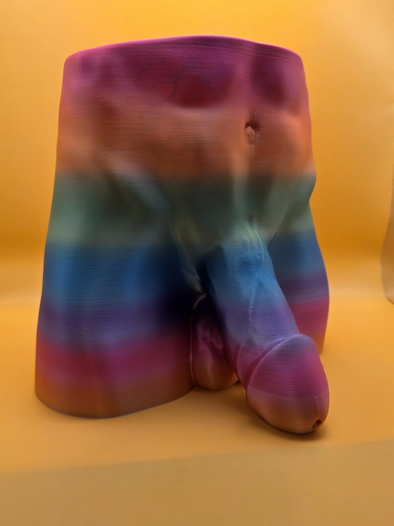Rainbow Monster Dong planter on yellow background