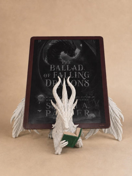 White Moonplume dragon stand holding an e-reader, with a green mini book