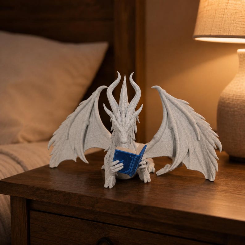 Empty white Moonplume dragon stand with wings spread and a blue mini book