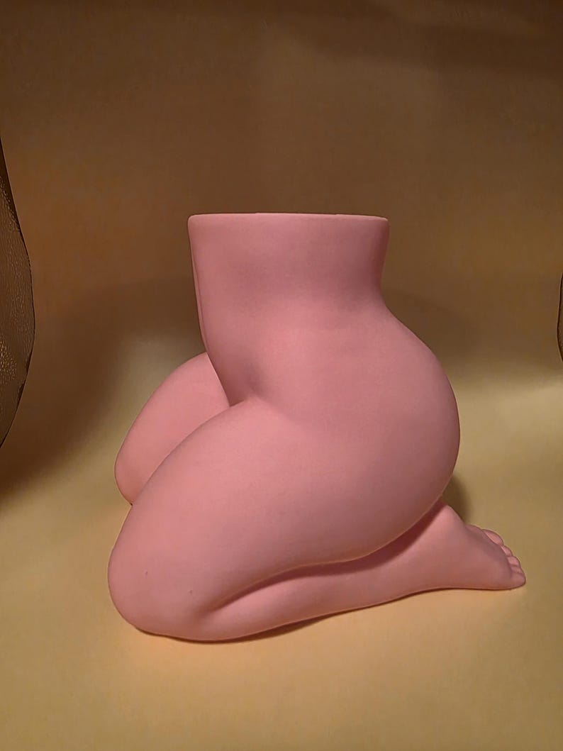 Pink Mrs. Gray kneeling planter, side view