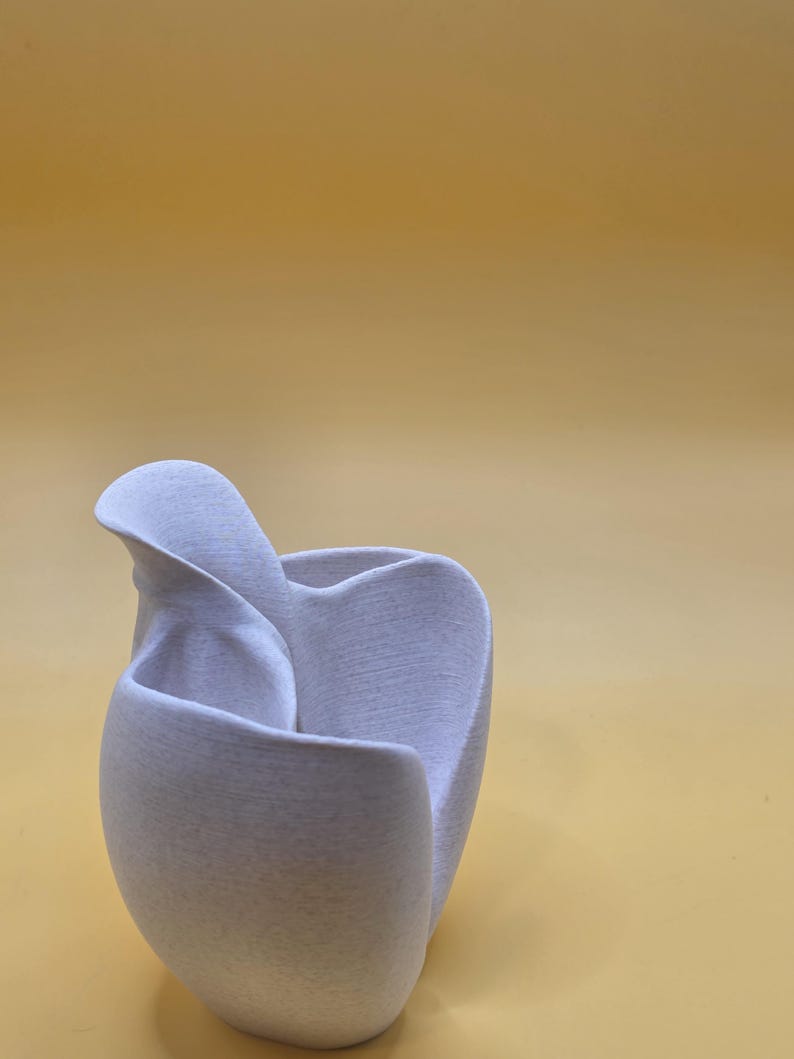 Bloom sculptural planter showing curved petal-like form