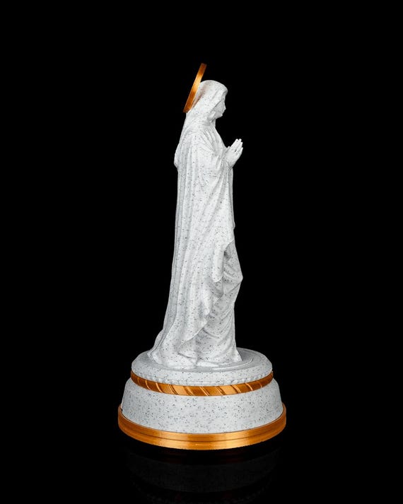 Our Lady statue with praying hands and gold halo