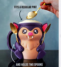 Purple and peach Bramble the Bat pint holder with a pint and two spoons