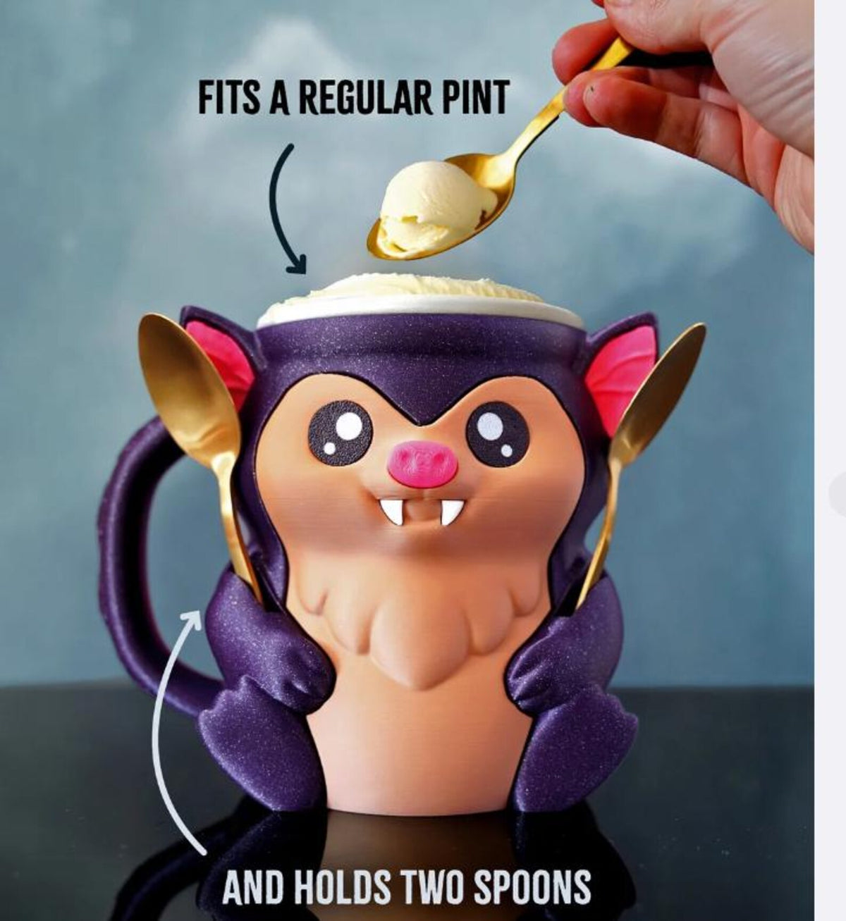 Purple and peach Bramble the Bat pint holder with a pint and two spoons