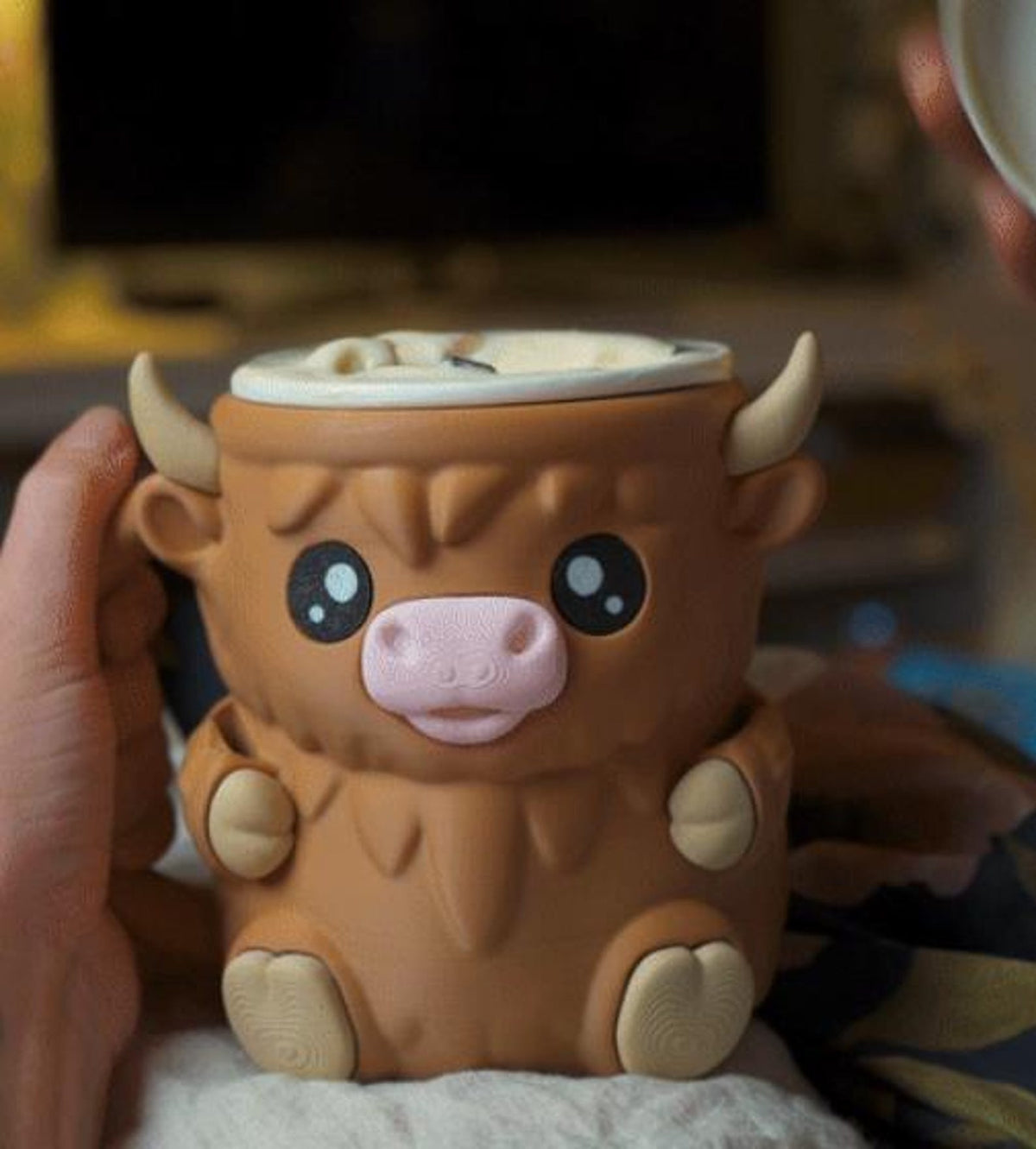 Front view of the brown Ferdinand the Highland Cow ice cream holder