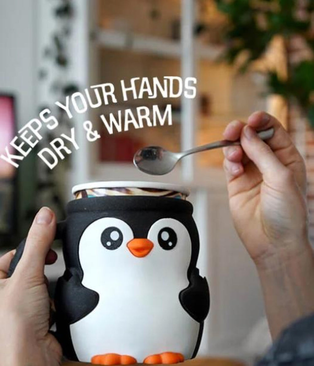 Hands holding Pebbles the Penguin pint holder with a spoon