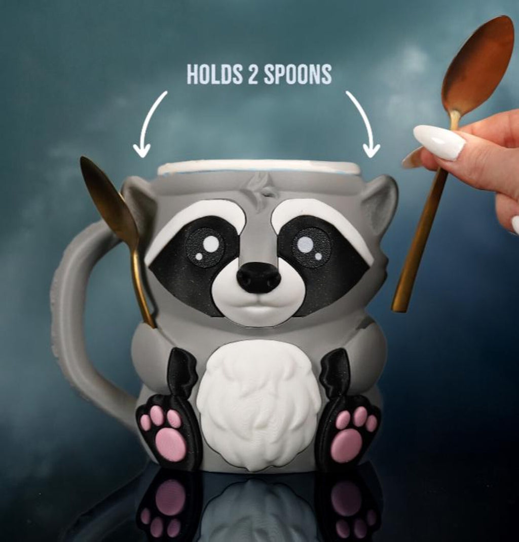 Rocky the Raccoon holder with two spoons in the arm slots