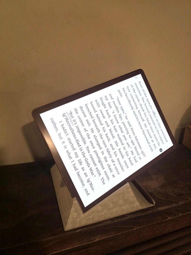 E-reader in landscape on a ReadRest stand on a wood table