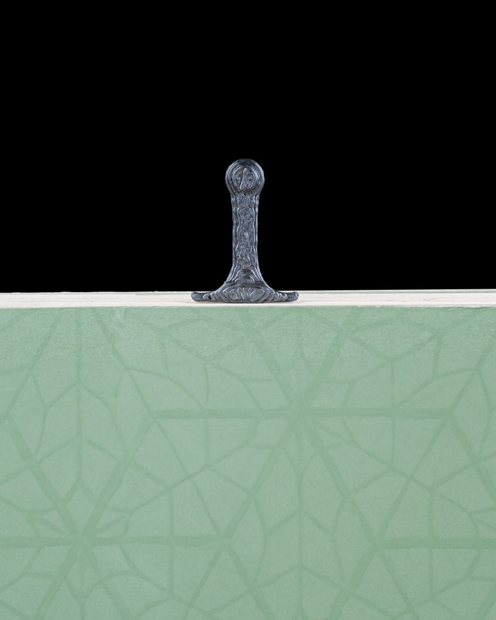 Sword bookmark handle visible above a closed book