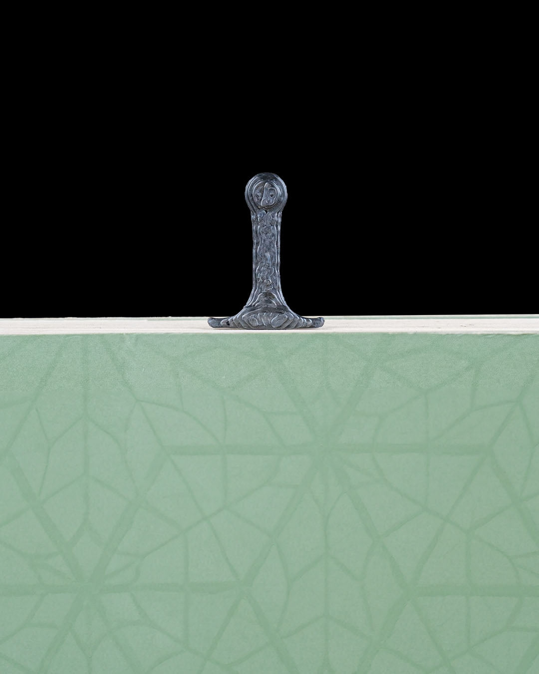 Sword bookmark handle visible above a closed book