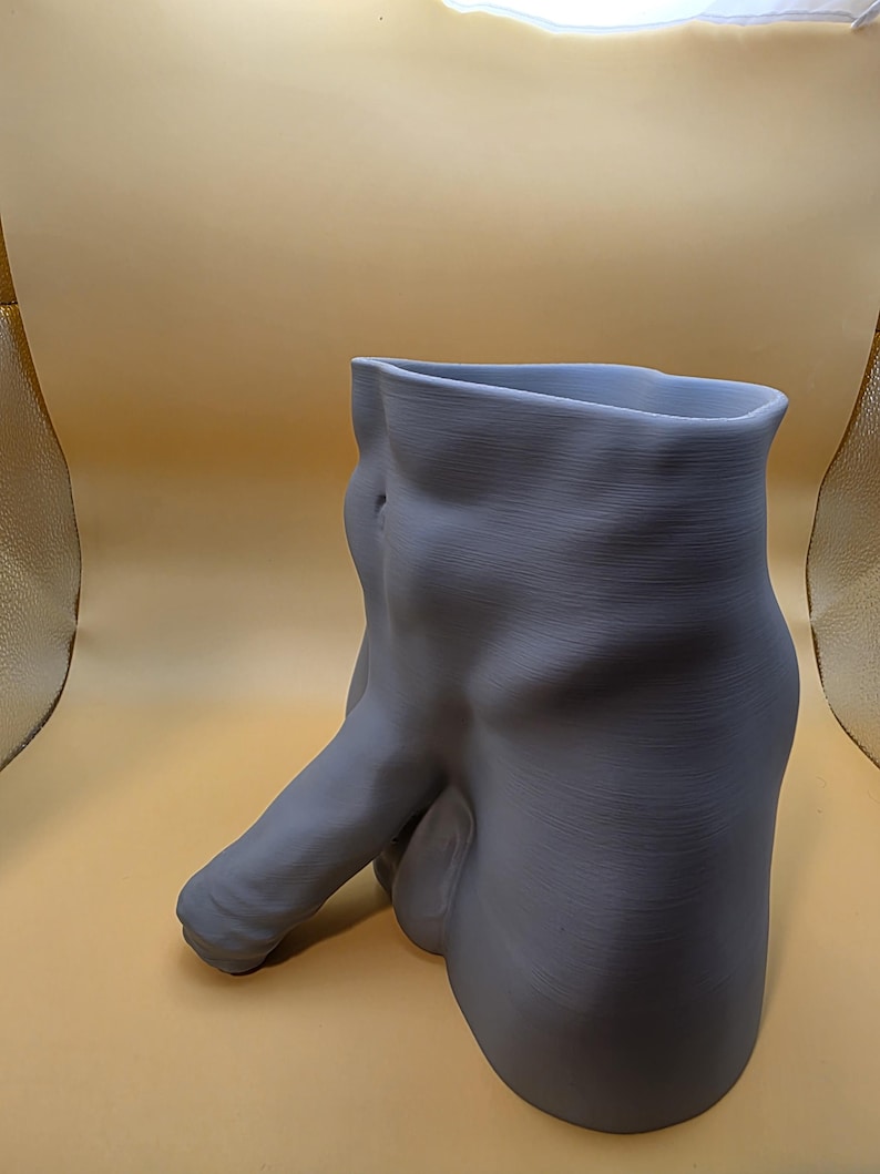 Gray Uncircumcised Monster Dong planter, angled side view