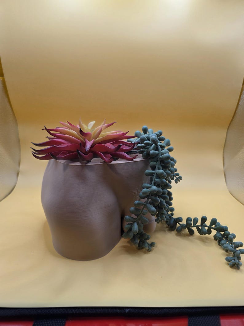 Taupe Unimpressed planter with succulents on a yellow backdrop