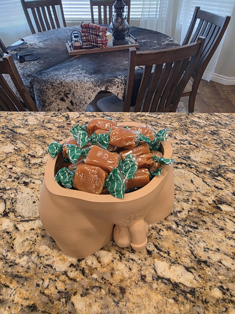 Tan Unimpressed planter filled with wrapped candies on a granite counter